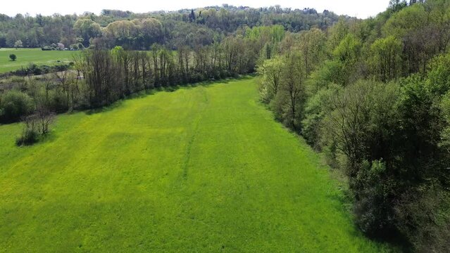 spectacular on top traveling aerial view of green field and trees