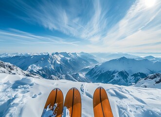 two orange skis standing on top of the snow covered mountain with beautiful view of mountains and blue sky in background stock photo contest winner, high resolution - Powered by Adobe