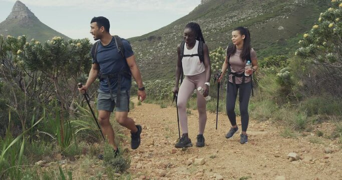 Trekking, nature rock and people relax on morning journey, cardio exercise or mountain climbing in South Africa. Walking break, dirt path and tire group hiking for workout, training and rest together