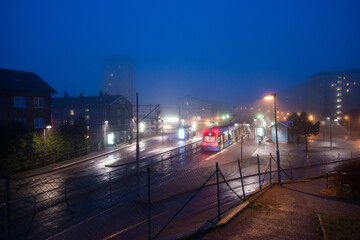 Tram stop on a foggy night.