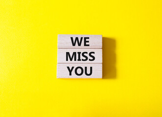 We Miss you symbol. Concept words We Miss you on wooden blocks. Beautiful yellow background. Emotion and We Miss you concept. Copy space.