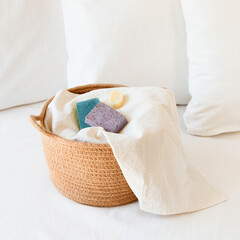 Fototapeta na wymiar Soaps on white towel inside a basket