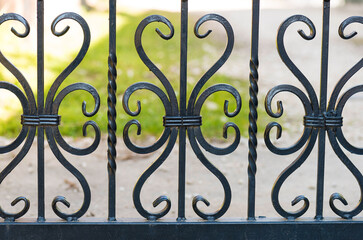Part of a metal forged fence. Forged metal detail on the fence, handmade