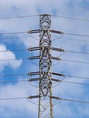 High voltage transmission pole with insulators and wires.