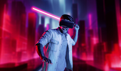 Gamer holding laser sword and playing action game while wearing VR glasses. Caucasian man using...