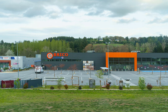 Brico Storefront and Parking Lot at Dusk