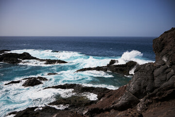 Black bay with blue ocean in Tenerife,  black voulcanic sand