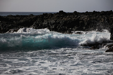 Black bay with blue ocean in Tenerife,  black voulcanic sand