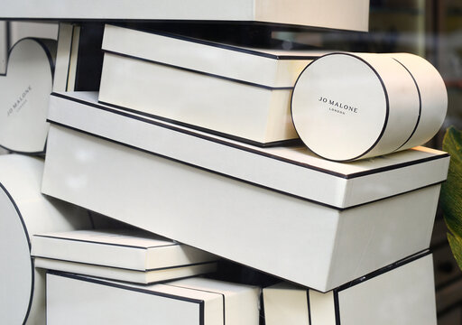 MILAN, ITALY – APRIL 11, 2024: Black and white cardboard boxes in the Jo Malone London shop window in Via Manzoni. Estée Lauder owns this perfume label since 1999
