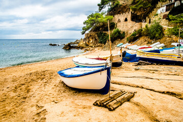 Boats on the beach of Sa Caleta in Lloret de Mar, Catalonia.
