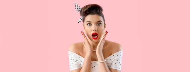 Shocked young pin-up woman on pink background, closeup