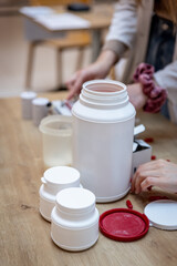Pharmacists preparing recepture drugs medicine in a pharmacy with mortars and capsules containers clean