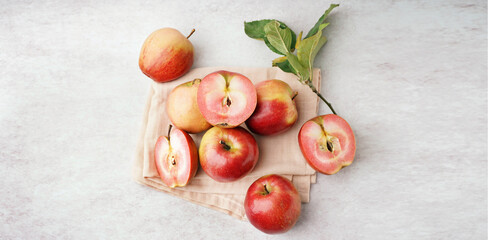 Sweet pink apples and leaves on white background