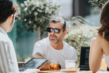 Multi generational business entrepreneurs strategize for success while analyzing data and brainstorming ideas at a modern coffee bar.