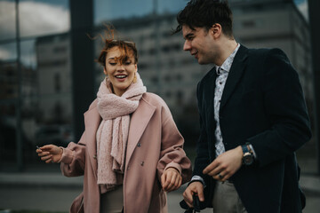 Two corporate colleagues in conversation outside office building, engaged in discussion with cityscape in the background.