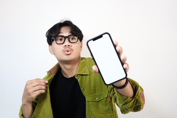 Adult Asian man smiling happy while showing his mobile phone screen and pointing on it