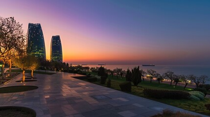 View of the famous Flame Towers illuminated and Caspian Sea at dusk, seen from Boulevard Park in...
