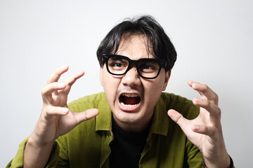 Portrait of young Asian man isolated on white background feeling frustrated with helpless facial...