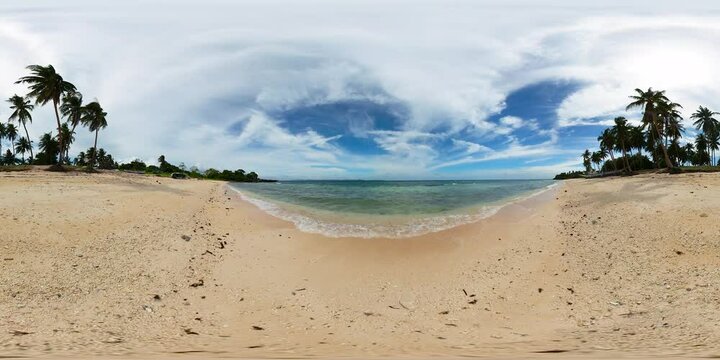 Ocean waves with bubbles crashing over sandy beach in Carabao Island in Romblon, Philippines. VR 360.