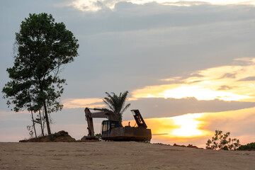 Excavating machinery at the construction site during sunset