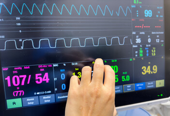 Hospital monitor displays vital signs in ICU, reflecting science and healthcare urgency