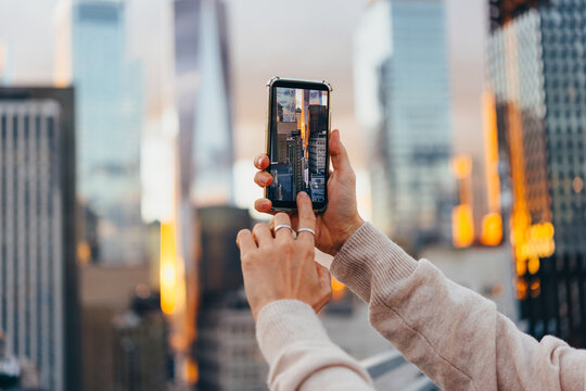 A person takes a mobile photo of the Manhattan skyline in New York City, United States.
