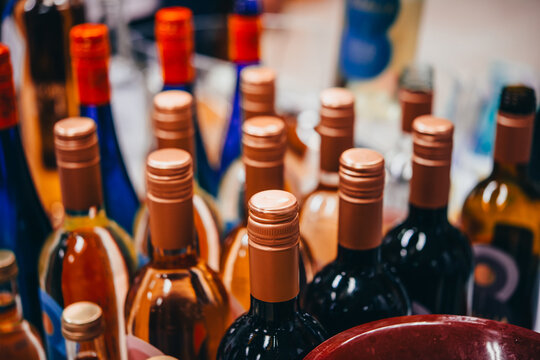 Wine bottles in a store or bar or restaurant.