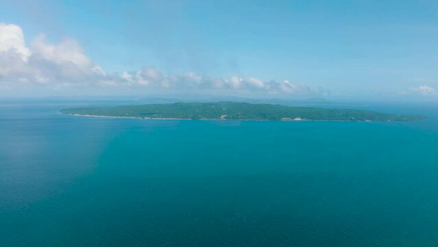 Drone view of Carabao Island surrounded by blue sea. Blue sky and clouds. Romblon, Philippines.