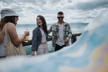 Cheerful friends sharing laughter by the lake on a leisurely holiday, embodying the joy of travel
