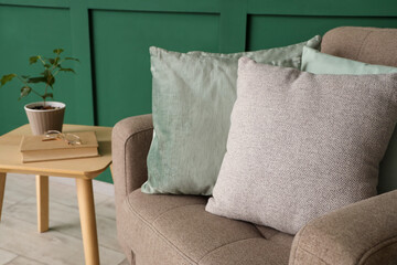 Soft pillows on armchair in living room, closeup