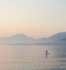 Person Standing on Surfboard in Water