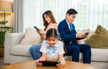 Family don't care about each other. Asian parents ignore their child and looking at their mobile...