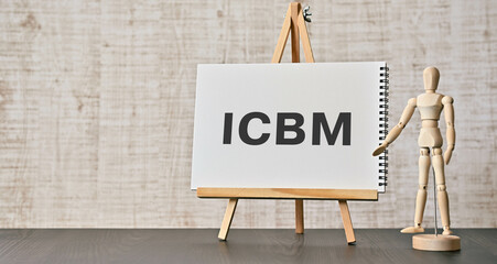 There is notebook with the word ICBM. It is an abbreviation for intercontinental ballistic missile as eye-catching image. - obrazy, fototapety, plakaty