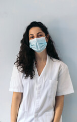 portrait of a female nurse smiling with mask