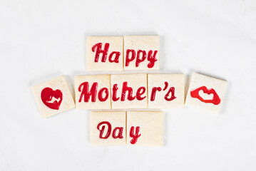 Modern square shortbread cookies with marmalade filling in the shape of the words happy mother's day and heart. White background. Top view. Mothers Day