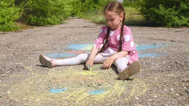 child hand drawing chalk asphalt, child kid childhood dream, little artist playground park girl daughter, playful child artist, child solo play, childhood artistic play, colorful chalk drawing