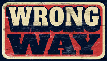Fototapeta premium Aged and worn vintage wrong way sign on wood
