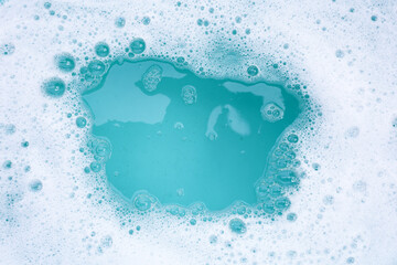 Detergent foam bubble on water. Blue background, Soap sud