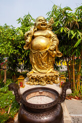 Statue of the Golden smiling Buddha or Hotei is the chinese god of happiness, wealth and good luck....