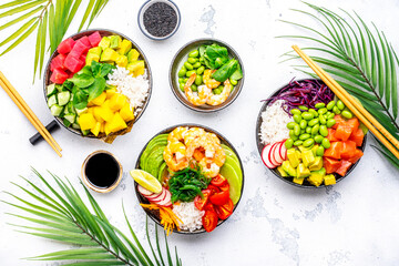 Poke bowls with vegetables and seafood set for balanced diet, white table background, top view - 792154301