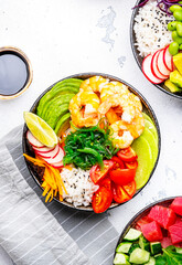 Poke bowls with vegetables and seafood in assortment, white table background, top view - 792154315