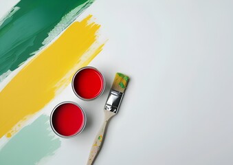 Cans of paint and paintbrush seen from above