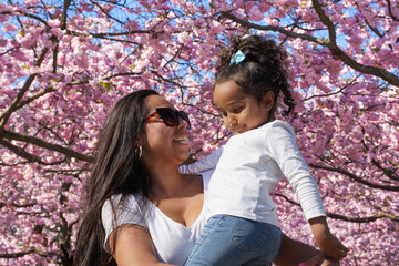 Portrait of mother and daughter at cherry tree