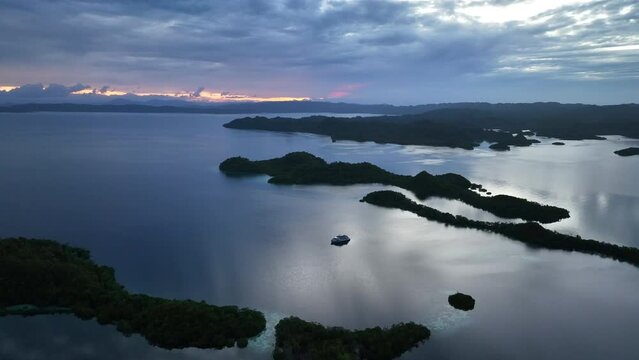 Daybreak illuminates the beautiful limestone islands of Pef in Raja Ampat, Indonesia. This remote, tropical region is known to harbor the world's greatest marine biodiversity.