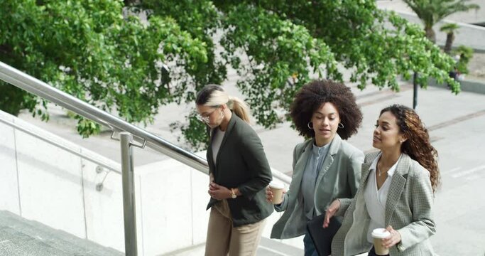 Steps, colleagues or business women in city walking for travel, journey or commute together to work. Building, people and professional female employees on stairs talking or speaking in conversation