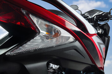 a rear body of a red scooter type motorbike.