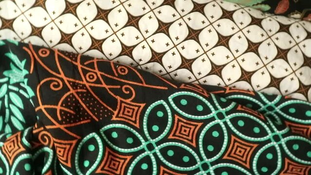 Spinning various motif of batic pattern fabric, Indonesia textured cloth background