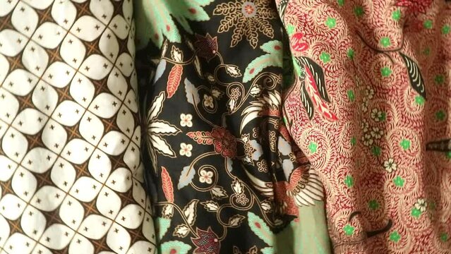 Spinning various motif of batic pattern fabric, Indonesia textured cloth background