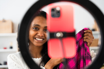 Closeup of Indian young woman live streaming on phone.