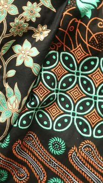 Spinning various motif of batic pattern fabric, Indonesia textured cloth background